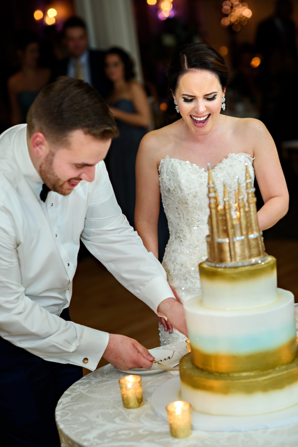 A Bride and Groom cut the wedding cake at their reception.